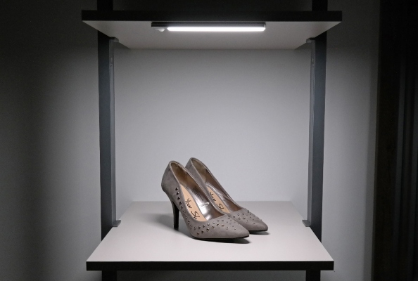 heels on a shelf with a spotlight