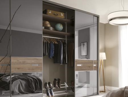 Floor to ceiling grey fitted wardrobe in bedroom